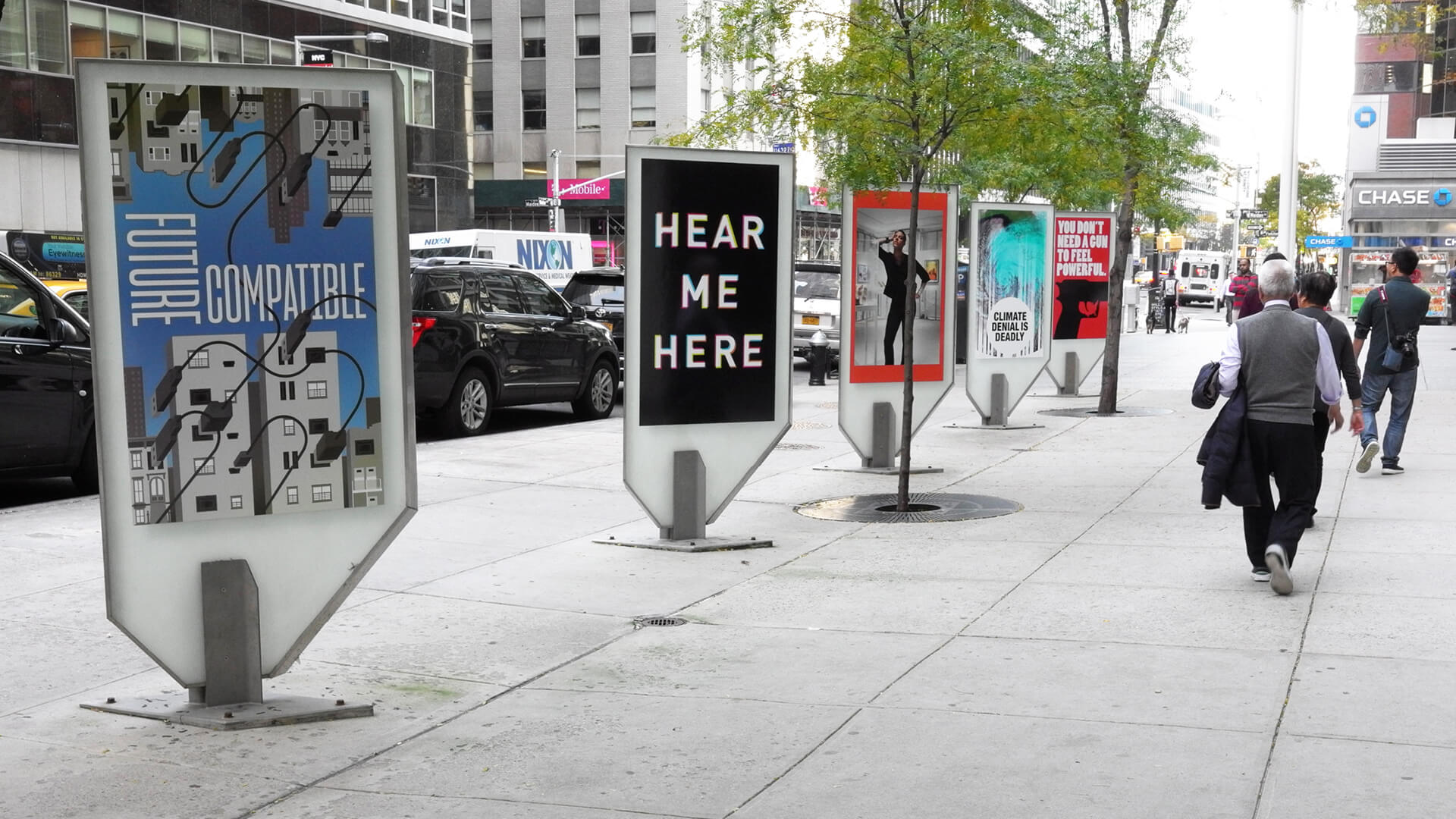 a New York street scene with Amplify posters lining the sidewalk