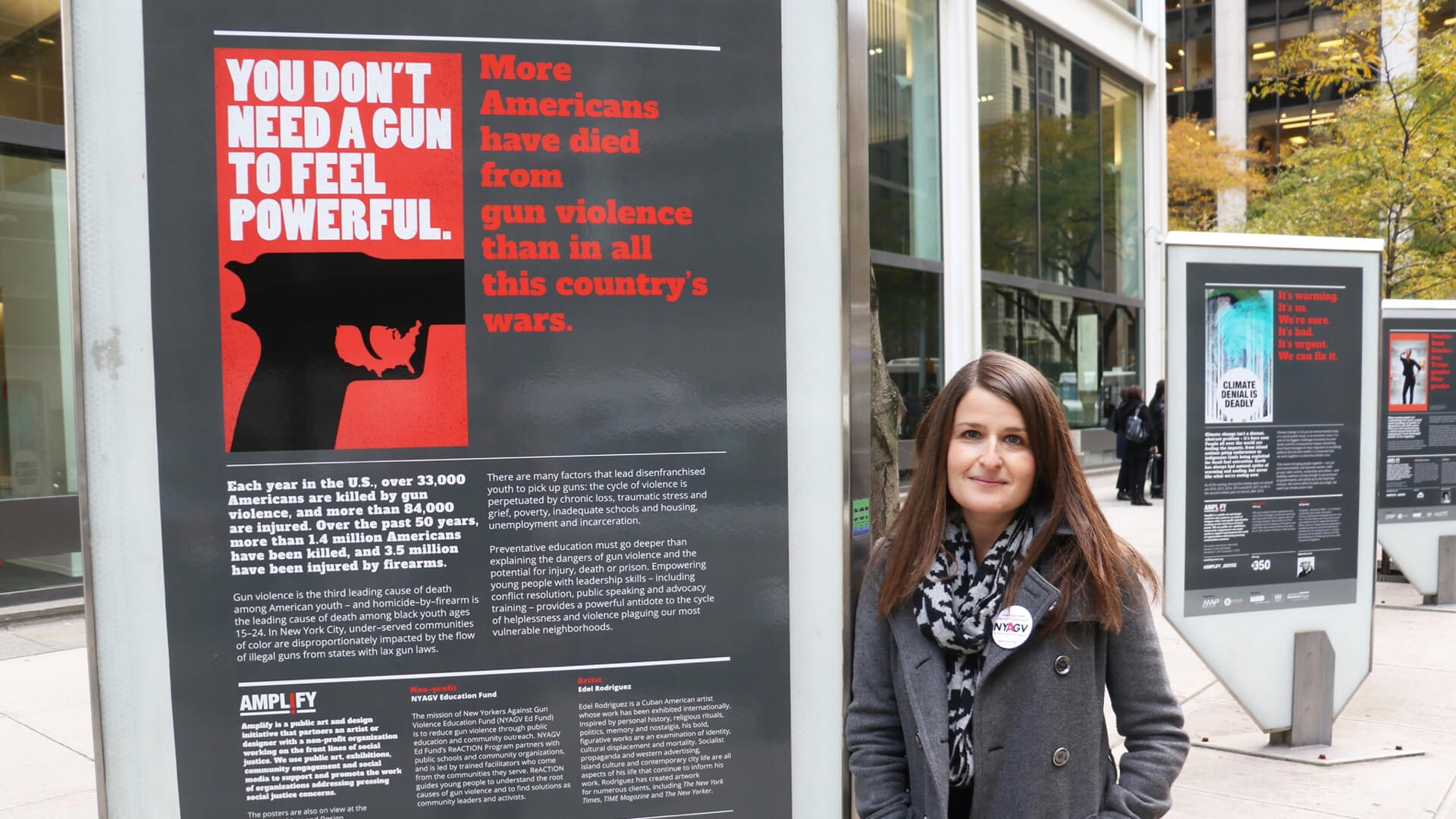 person leans against a poster vitrine